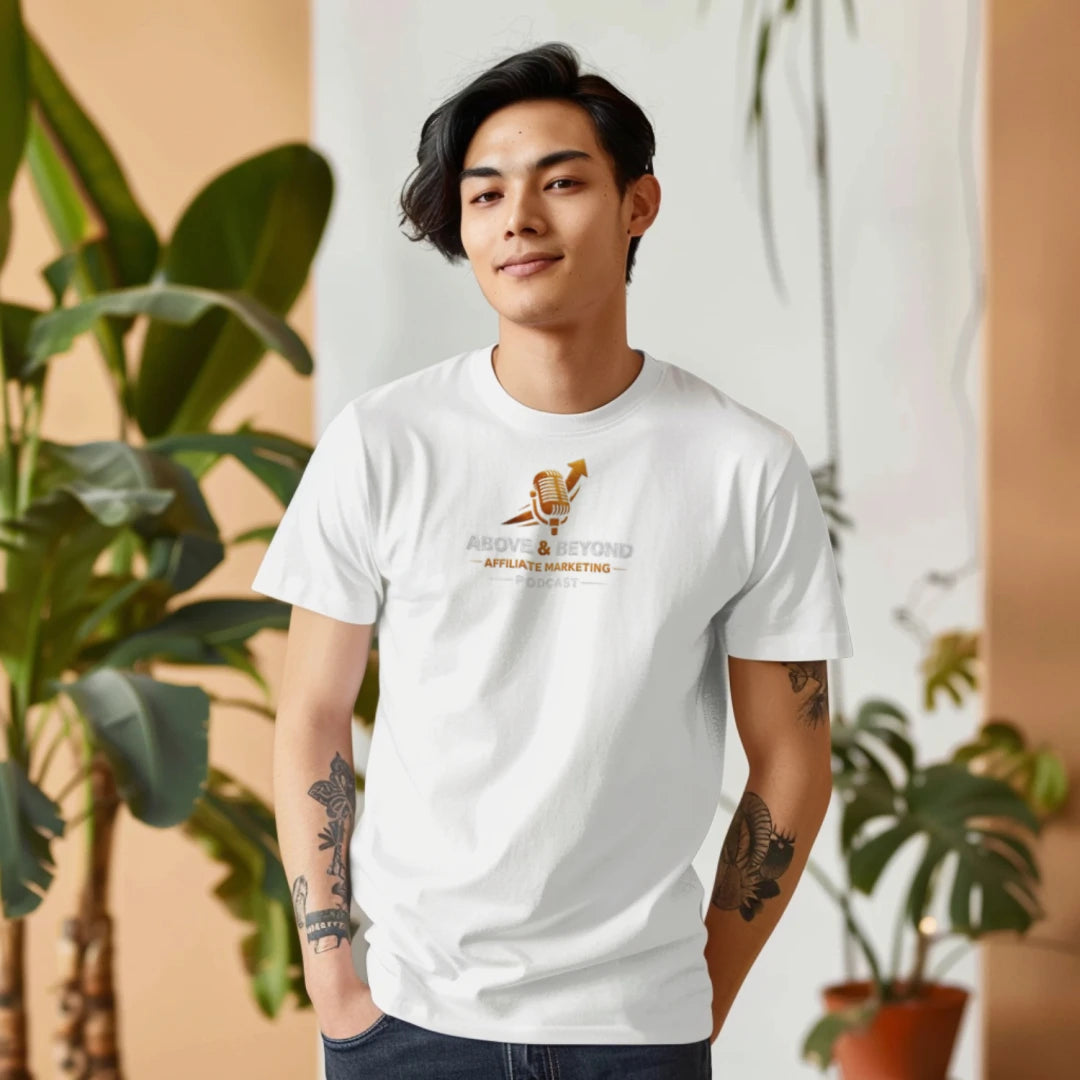 Person wearing a Above and Beyond Affiliate Marketing Podcast t-shirt with 'The Light Shines' text, standing in front of plants.