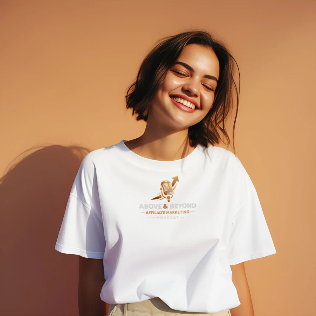 Woman wearing a white t-shirt with a Above and Beyond Affiliate Marketing Podcast logo and text on a beige background.
